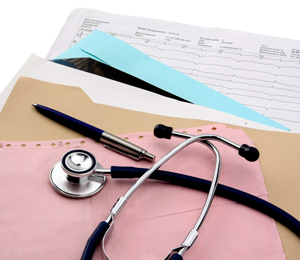 Patient forms in a file and a stethoscope and pen lying on top of it 