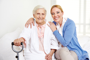 Two females (one female elderly patient) sitting next to each other. 